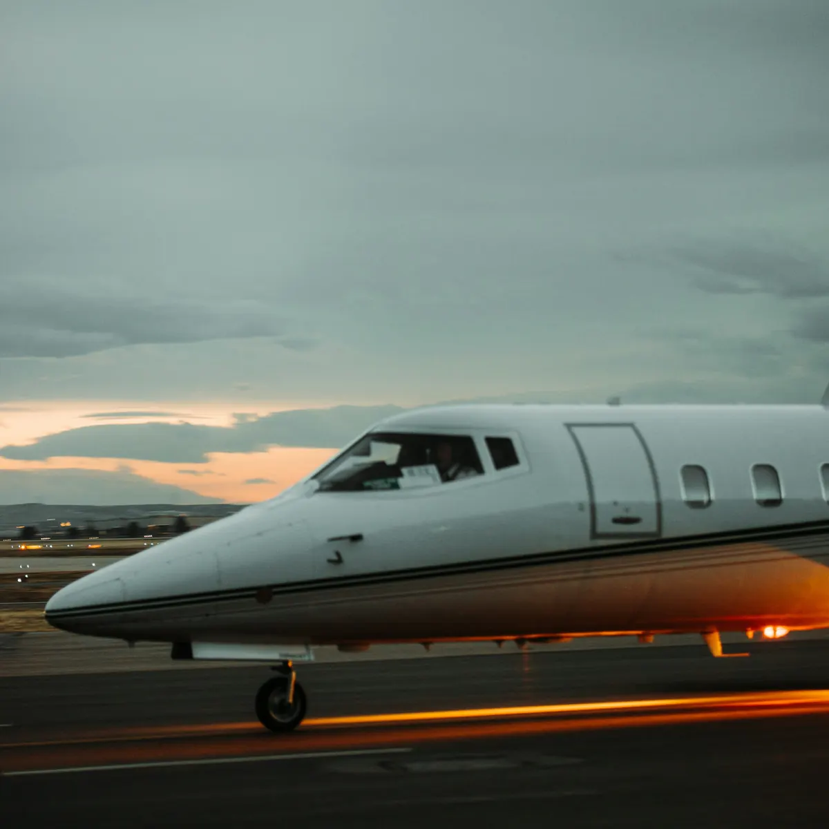 Large business jet on the ramp under an evening sky