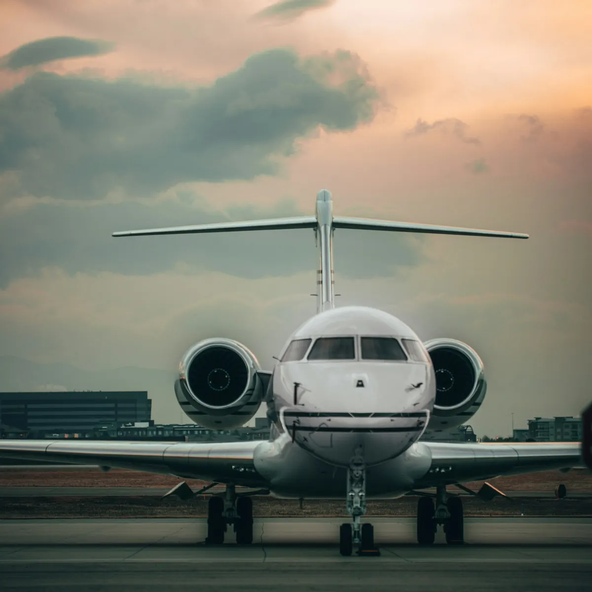Business jet facing the camera on the ramp at dusk
